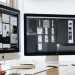 2 computer screens with web design software
